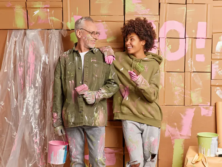 Happy family painting moving boxes, showcasing security and instant contract exchange after bidding