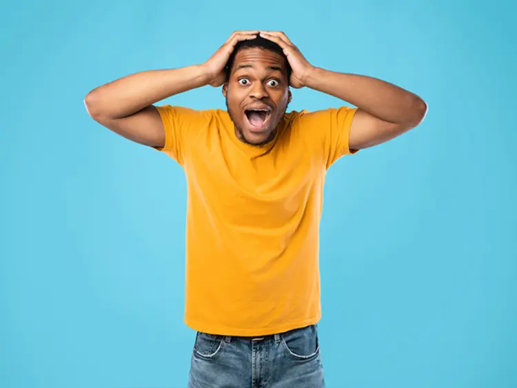 Surprised man in a yellow shirt reacting to fast-paced bidding, highlighting the speed of property transactions